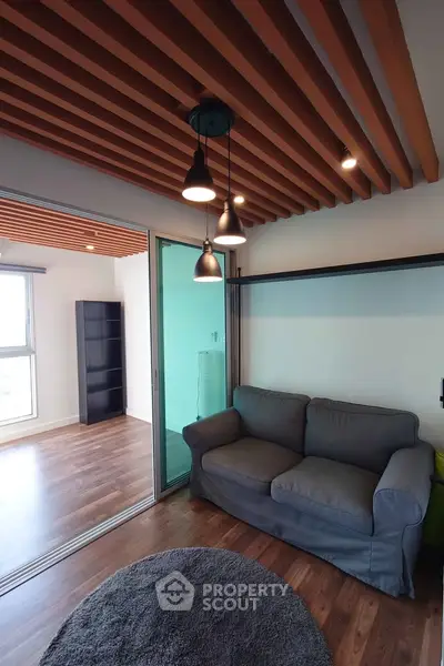 Modern living room with stylish wooden ceiling and cozy gray sofa