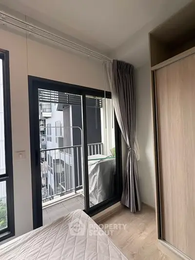 Modern bedroom with balcony access in urban apartment