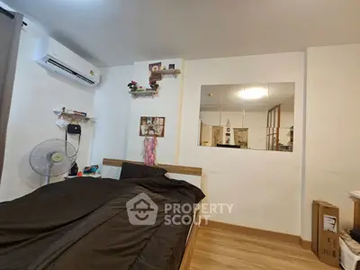 Cozy bedroom with modern decor and air conditioning, perfect for relaxation.