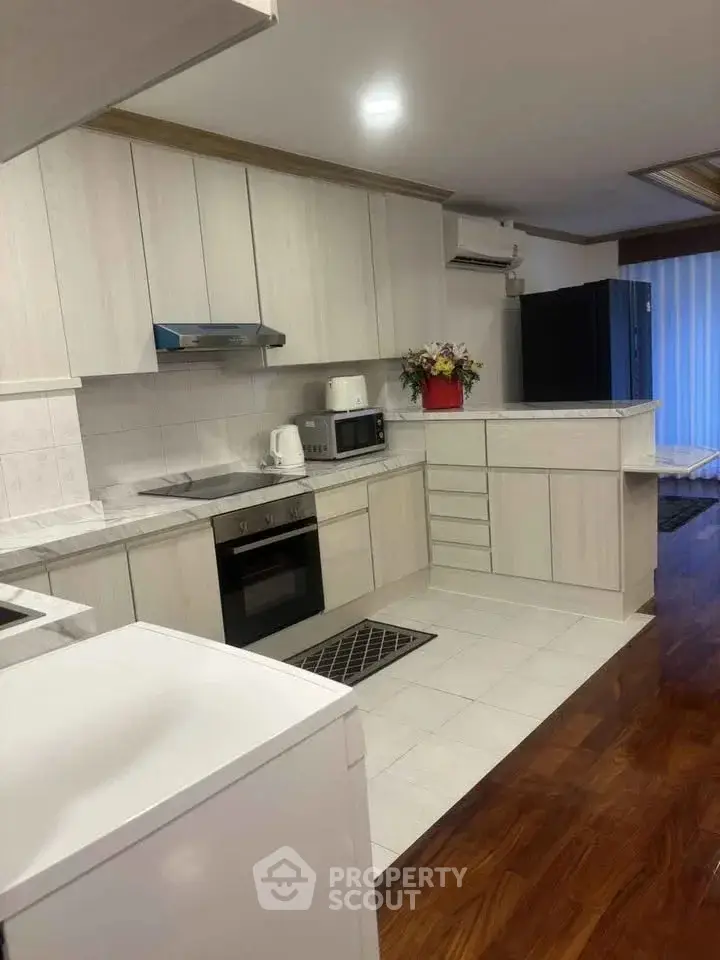Spacious kitchen with modern appliances and sleek cabinetry in a stylish home.