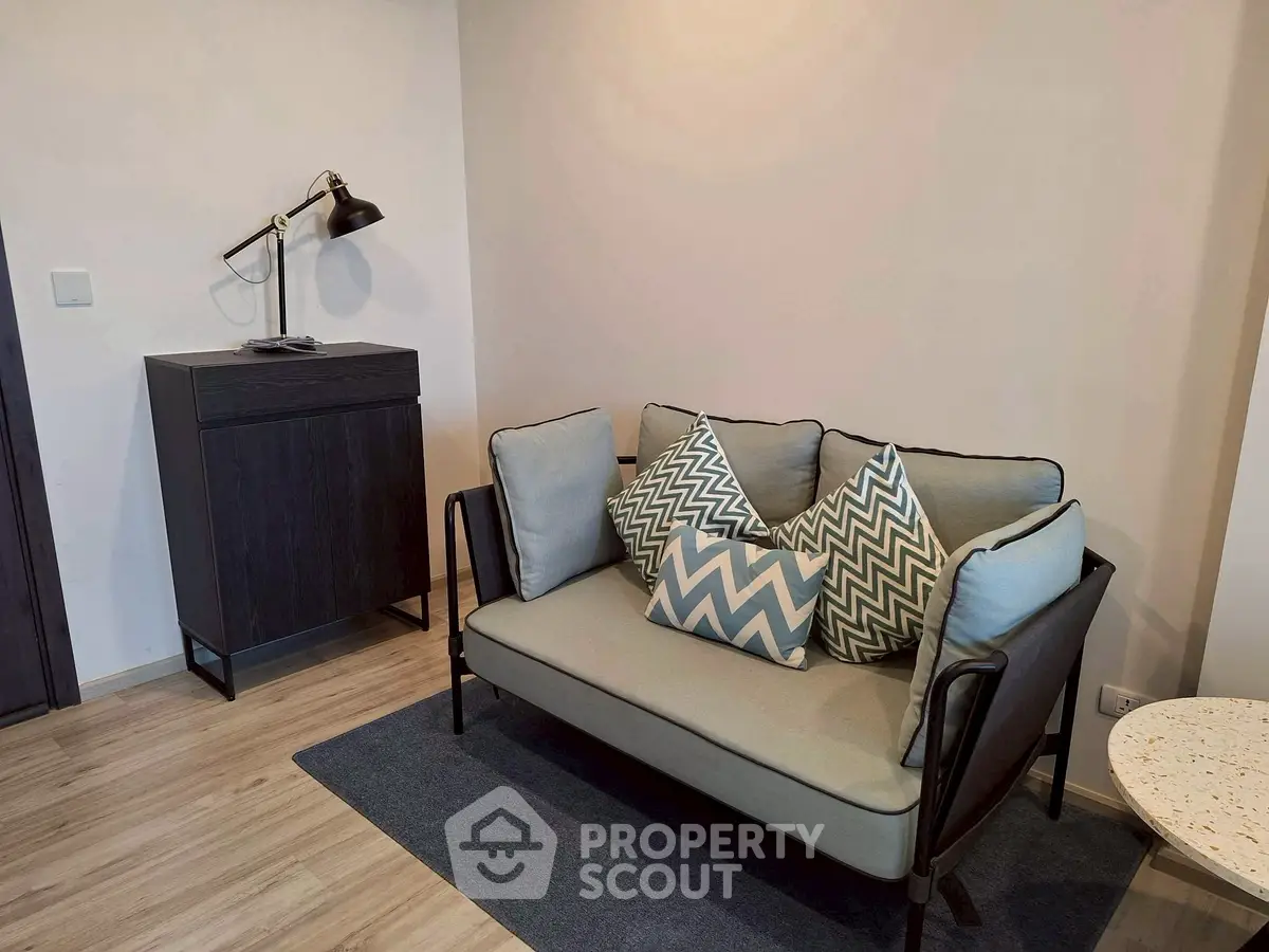Modern living room with stylish sofa and chic decor in a cozy apartment setting.