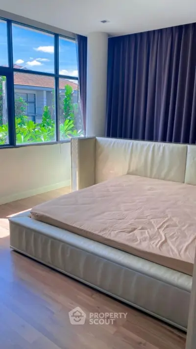 Spacious bedroom with large windows and modern design