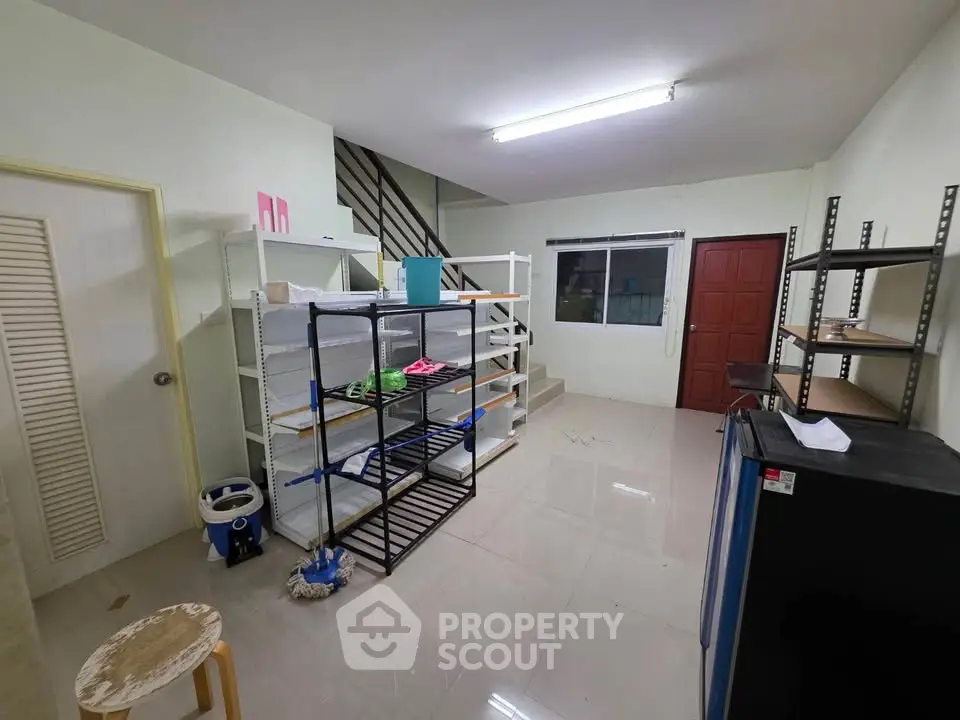 Spacious storage room with shelves and tiled flooring