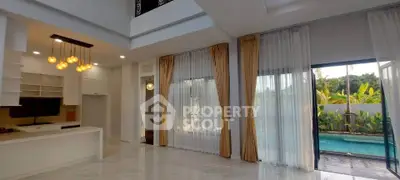 Luxurious open-plan living room with pool view and elegant lighting in modern home.