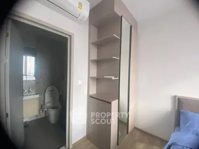 Modern bedroom with ensuite bathroom and sleek storage unit