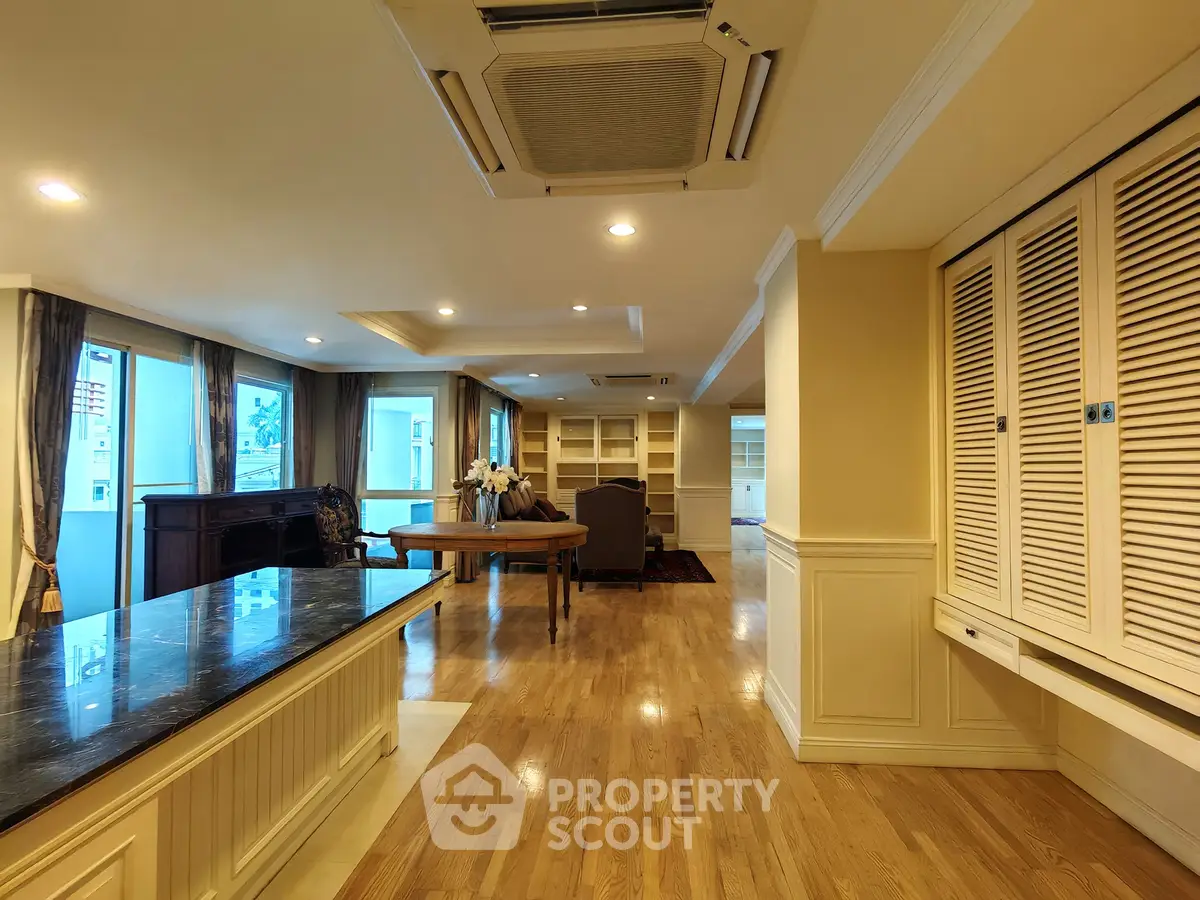 Spacious living room with hardwood floors and elegant furnishings