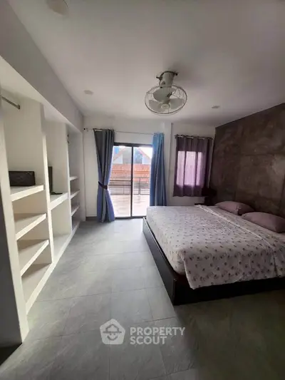 Spacious bedroom with balcony access and modern decor