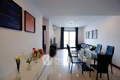 Spacious modern living room with elegant dining area and natural light.