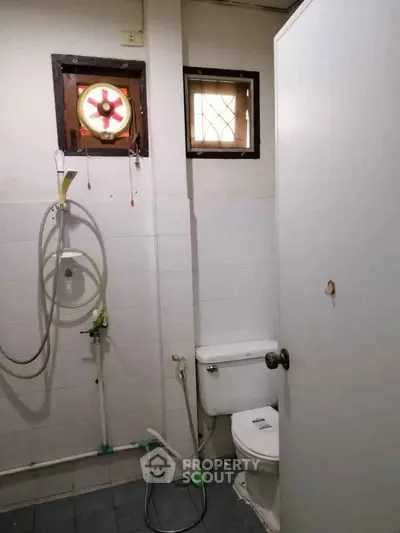 Compact bathroom with basic fixtures and small window