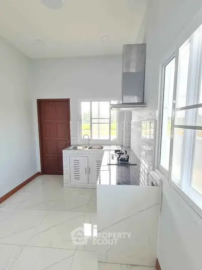 Modern kitchen with sleek white cabinetry and gas stove