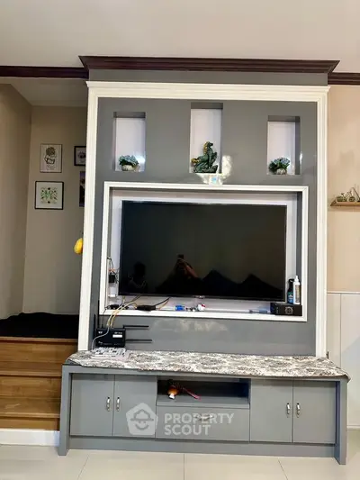 Stylish living room with modern TV unit and decorative accents.