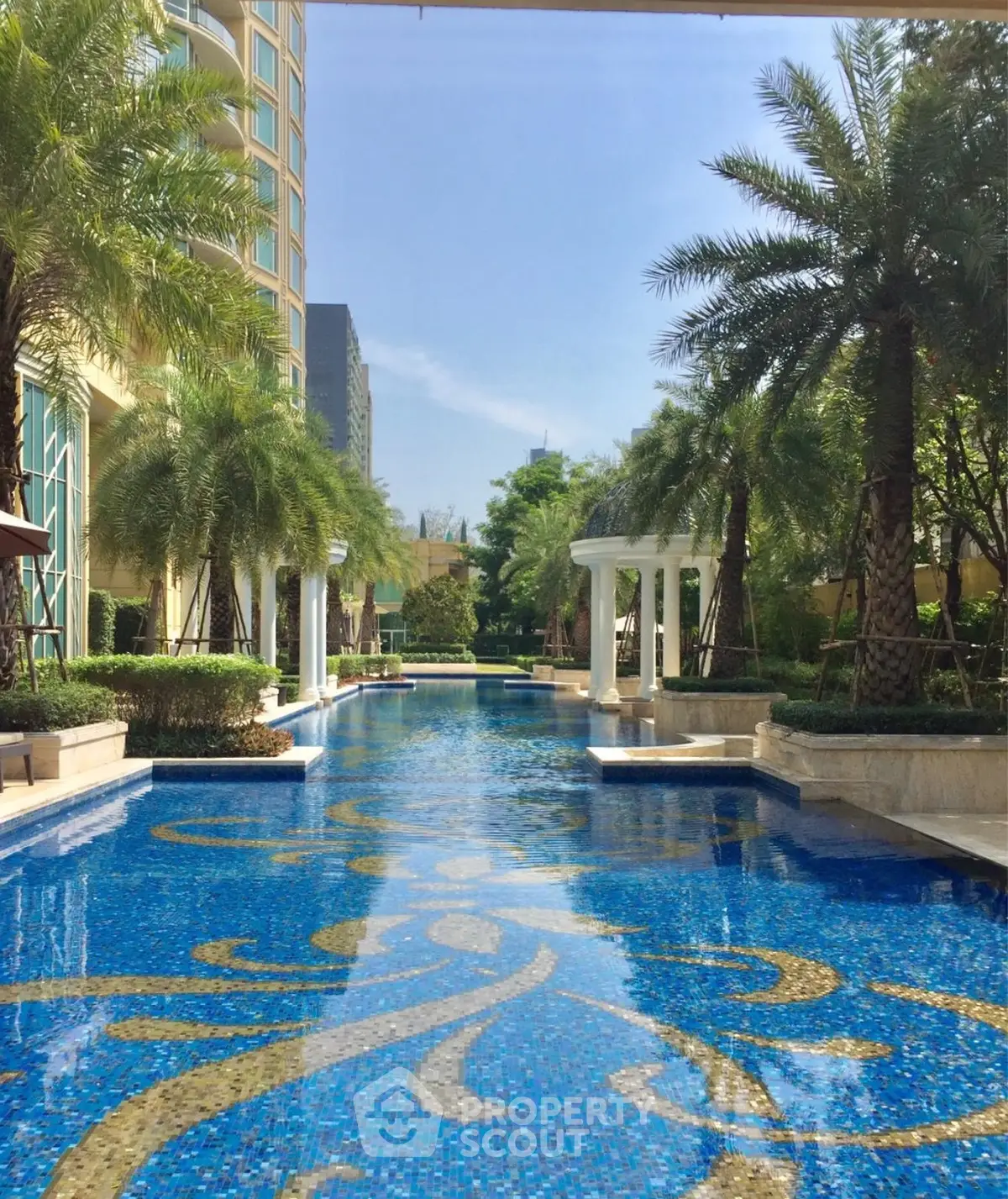 Luxurious condominium pool with palm trees and elegant design
