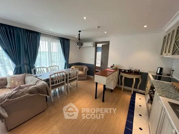 Charming open-layout living room and kitchen with elegant decor and natural light.