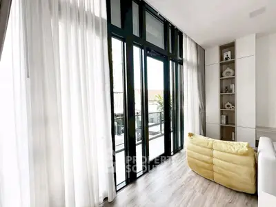 Spacious living room with floor-to-ceiling windows and modern decor