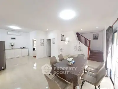 Spacious open-plan dining area with modern decor and natural light