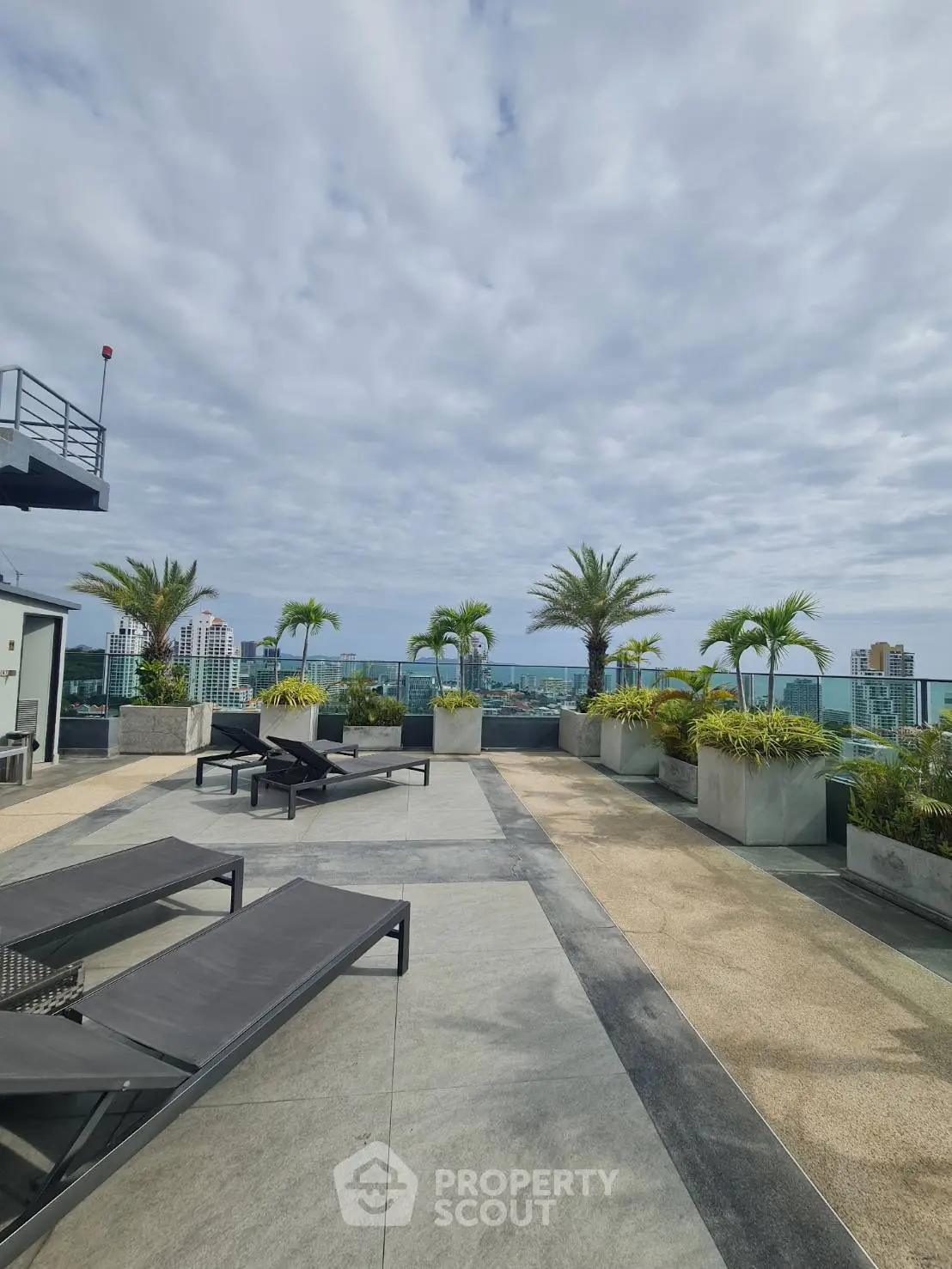 Luxurious rooftop terrace with stunning city views and modern lounge chairs.
