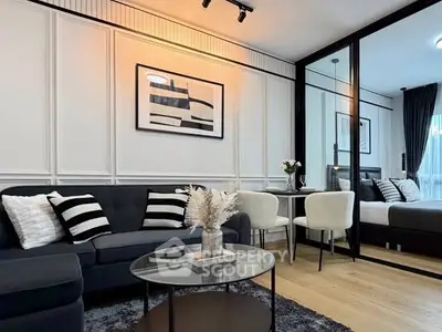 Modern living room with stylish decor and open layout, featuring a cozy seating area and elegant dining space.
