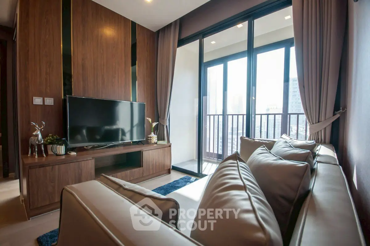 Luxurious living room with modern decor and city view balcony, perfect for urban living.