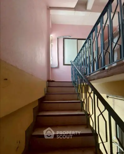 Charming staircase with vintage railing in a cozy residential building
