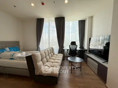 Modern studio apartment with stylish furniture and city view