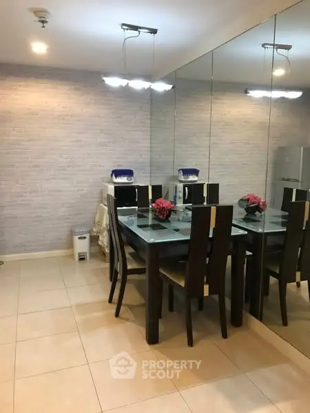 Elegant dining area with mirrored wall and modern lighting, perfect for stylish entertaining.