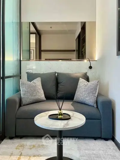Cozy modern living room with stylish sofa and marble coffee table in a chic apartment.