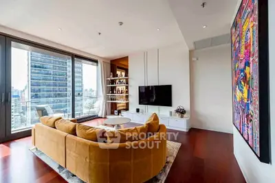 Luxurious living room with modern decor and stunning city view from large windows.