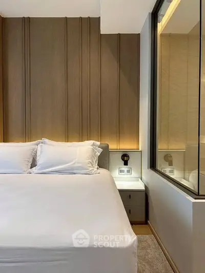 Luxurious modern bedroom with elegant wood paneling and soft ambient lighting.
