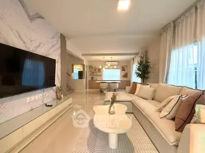 Luxurious living room with modern decor and large TV, perfect for relaxation.