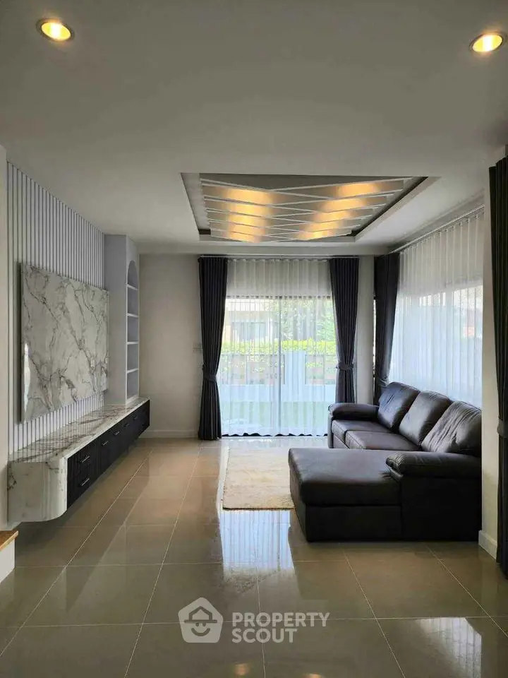 Modern living room with sleek design and large windows for natural light
