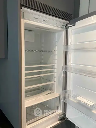Modern kitchen with sleek built-in refrigerator showcasing ample storage space.