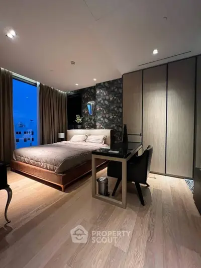 Luxurious bedroom with modern decor and large windows offering stunning city views.