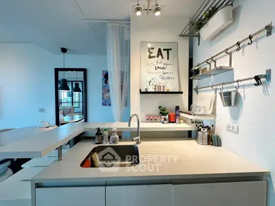 Modern kitchen with sleek design and open layout, featuring stylish shelving and contemporary decor.