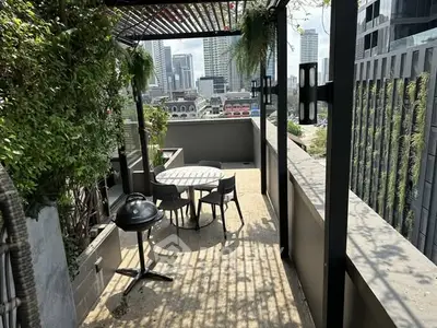 Stunning urban balcony with city skyline view and outdoor dining area.