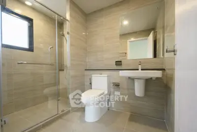 Modern bathroom with glass shower and sleek fixtures
