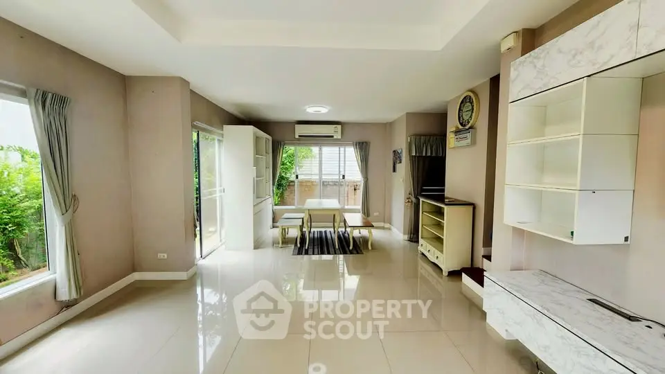 Spacious living room with modern design and large windows offering natural light.