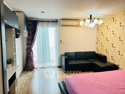 Modern bedroom with stylish decor and balcony access in a cozy apartment.