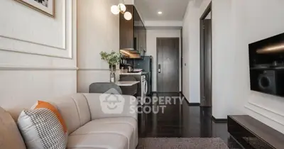 Modern living room with sleek design, featuring a cozy sofa and integrated kitchen appliances.