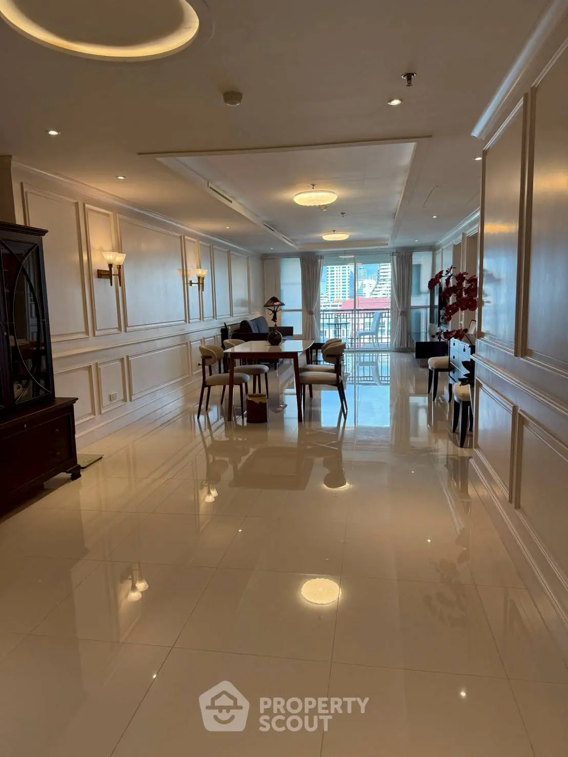 Elegant dining area with polished floors and city view, perfect for entertaining guests.