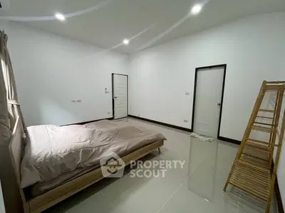 Spacious minimalist bedroom with modern design and natural light