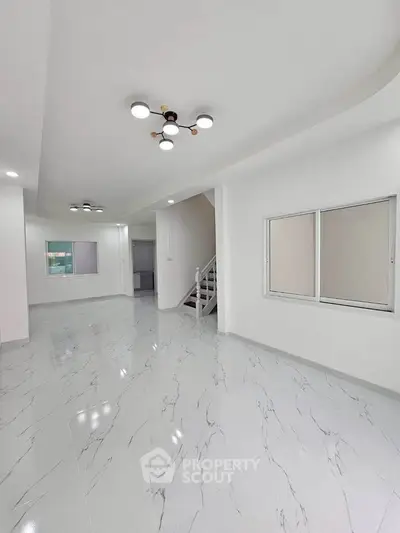 Spacious modern living room with elegant marble flooring and stylish lighting