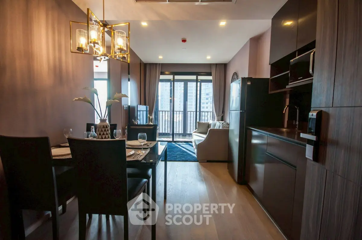 Modern open-layout kitchen and living room with stylish decor and balcony view.