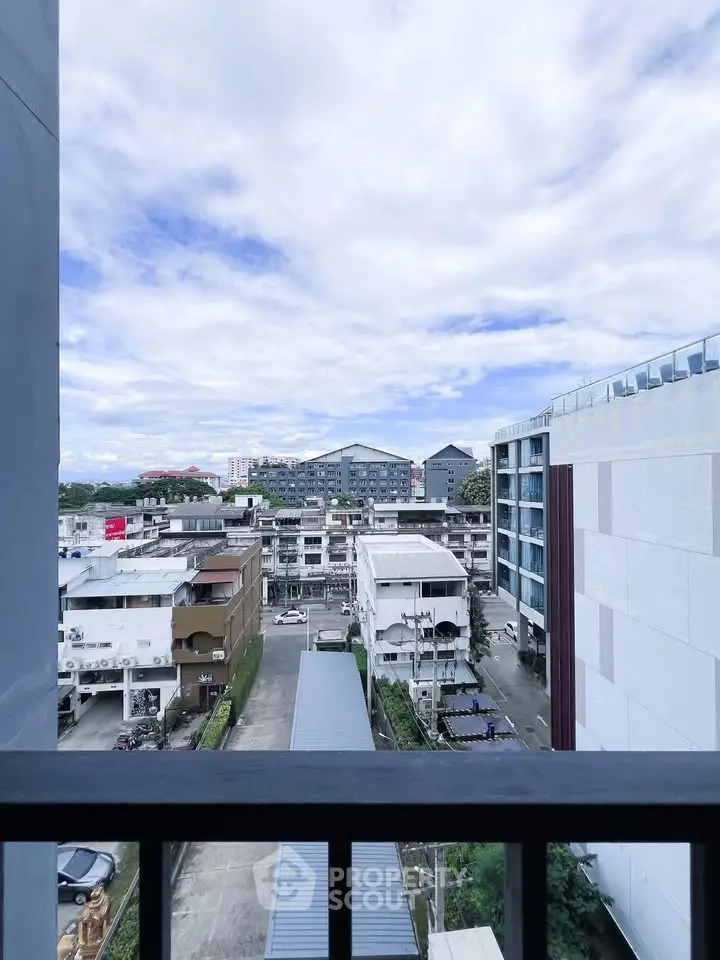 Stunning urban view from a high-rise balcony showcasing cityscape and modern architecture.