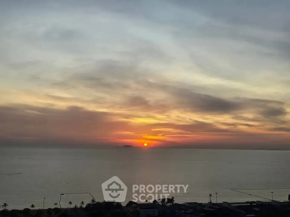 Stunning ocean view at sunset from a high-rise building, perfect for serene living.