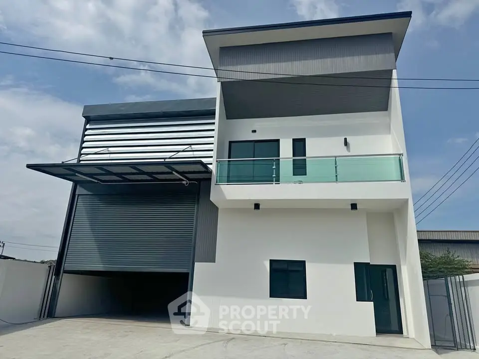 Modern industrial building with sleek design and spacious garage entrance