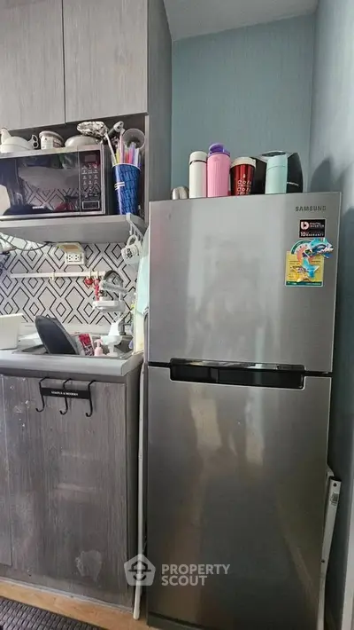 Modern kitchen with sleek fridge and stylish backsplash