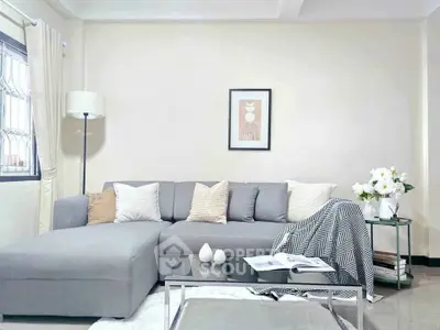 Stylish living room with modern gray sectional sofa and chic decor