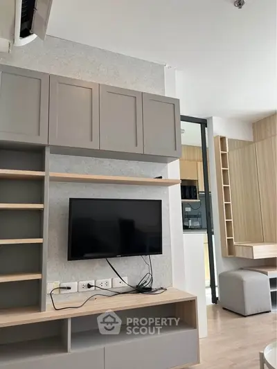 Modern living room with sleek cabinetry and wall-mounted TV
