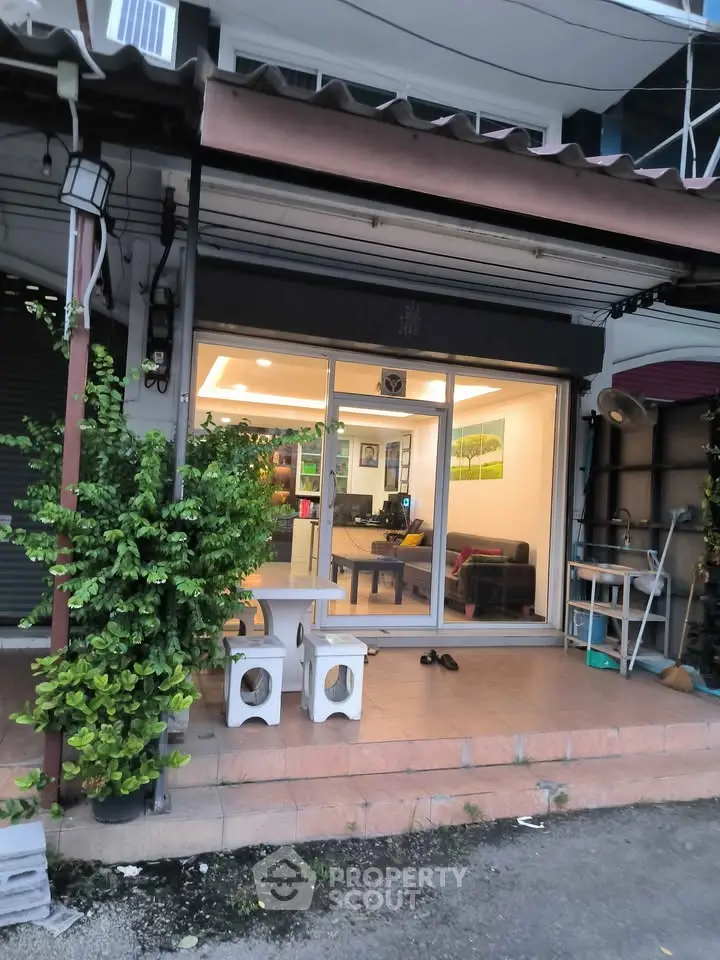 Charming storefront with inviting interior and cozy outdoor seating area.