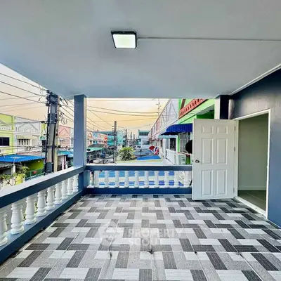 Spacious balcony with modern tile flooring and city view, perfect for relaxation.